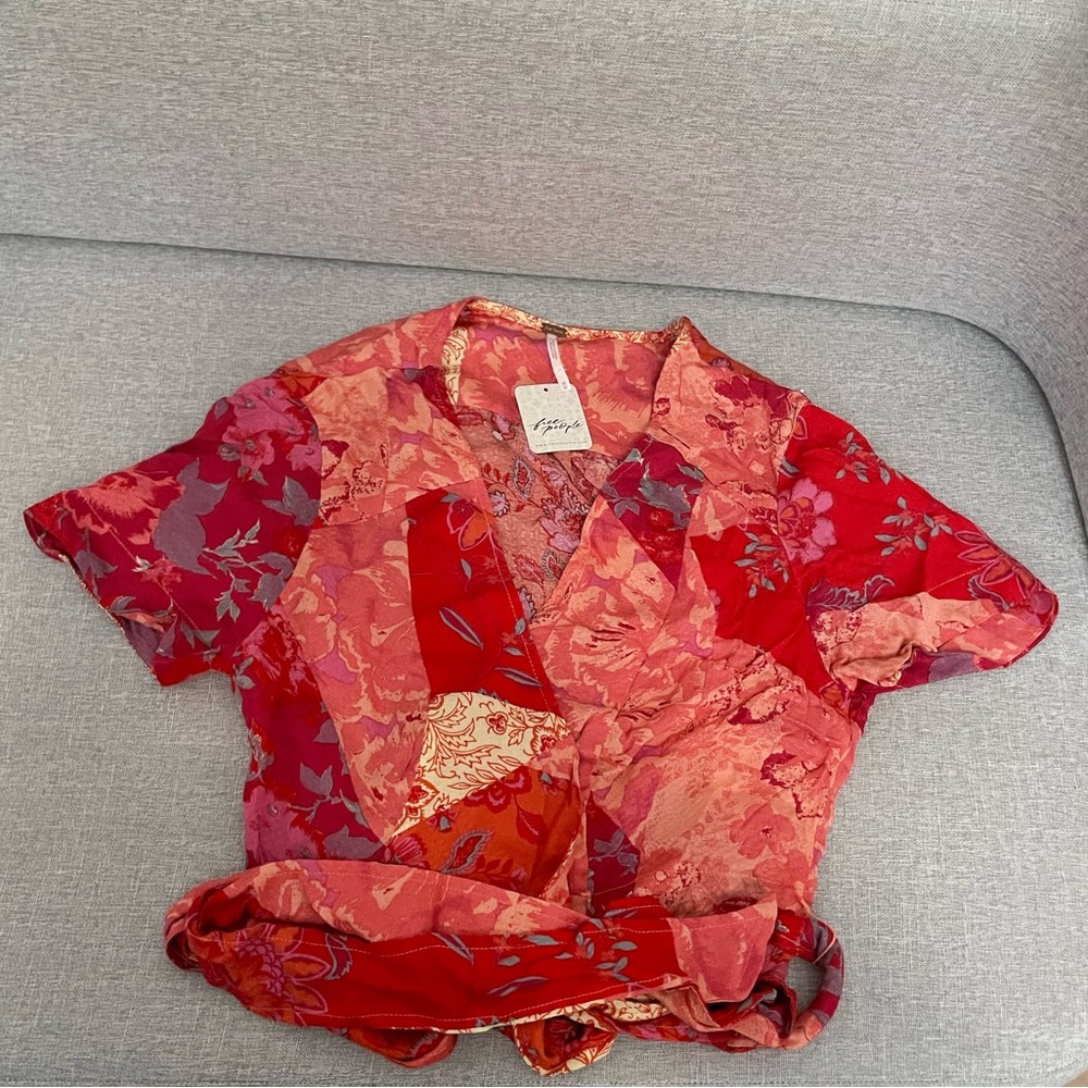 Free people multicolored Ashley Top. Unique blouse with fabric tie at bottom.